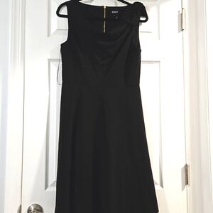 DKNY sleeveless little black dress with gold zipper with one shoulder bow.